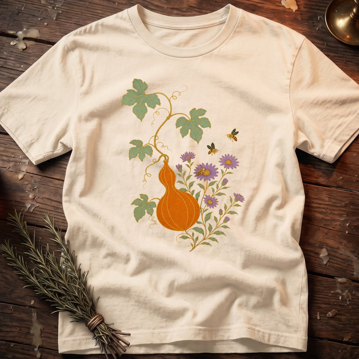 Cream t-shirt with orange gourd, purple flowers, green leaves, and bees design.