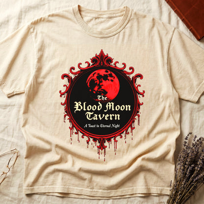 Ivory tee with red oval frame, blood-red moon, "The Blood Moon Tavern," "A Toast to Eternal Night," red drips below.