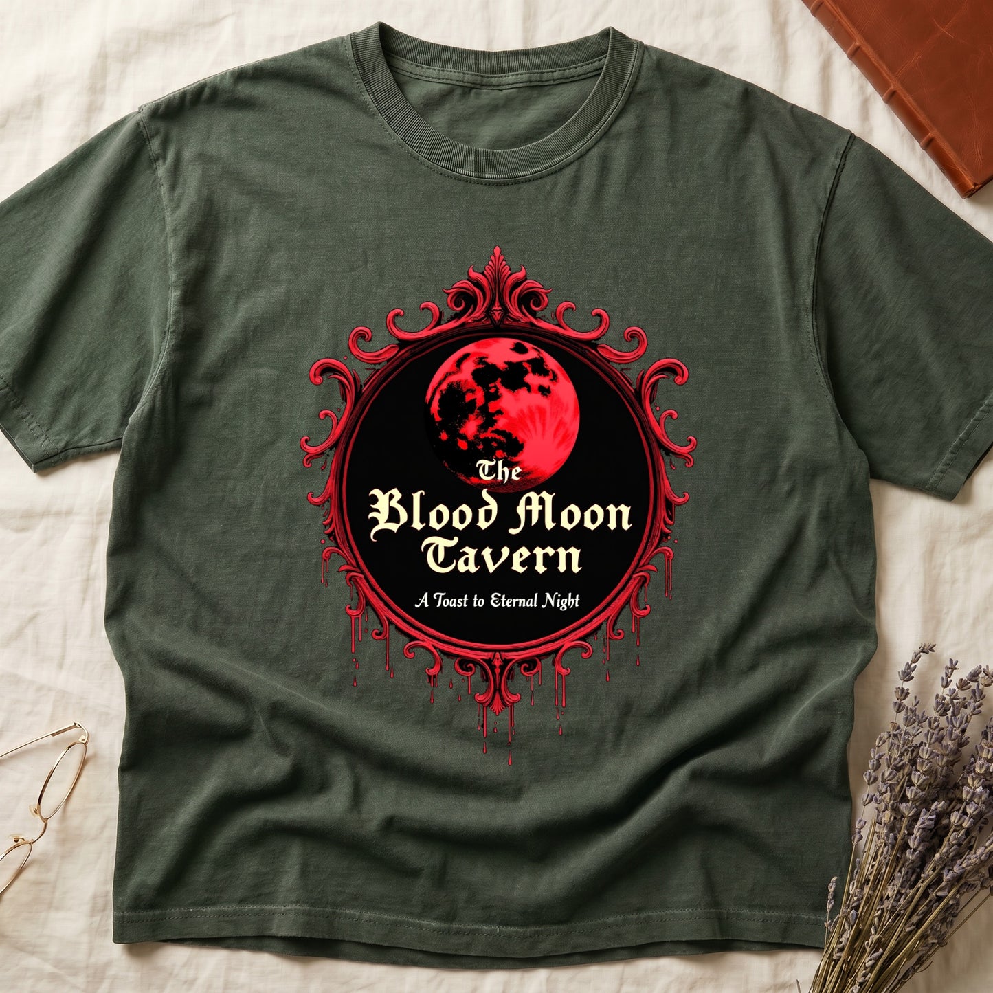 Green tee with red oval frame, blood-red moon, "The Blood Moon Tavern," "A Toast to Eternal Night," red drips below.
