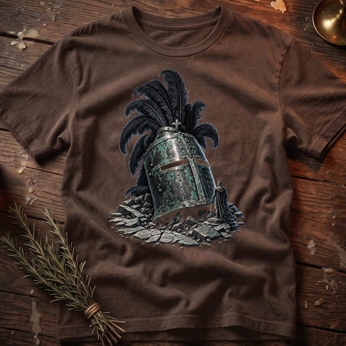 Brown t-shirt with graphic of a cracked, mossy knight's helmet with black feathers and a small king statue.