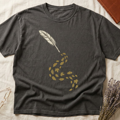 Pepper tee with antique quill pen in cream linework, oak and maple leaves cascading from the nib in gold and green.