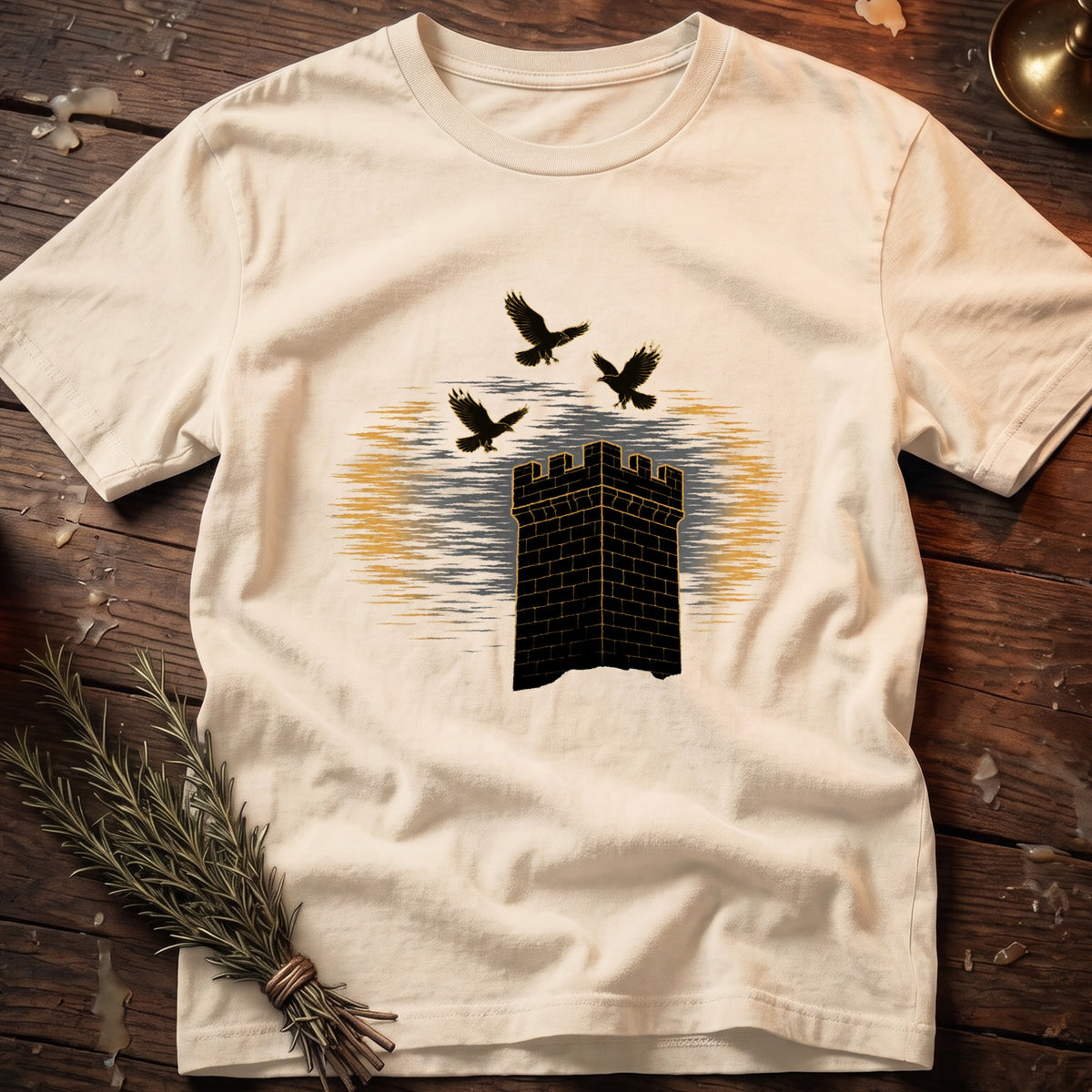 Cream t-shirt with a black brick tower and three birds graphic.