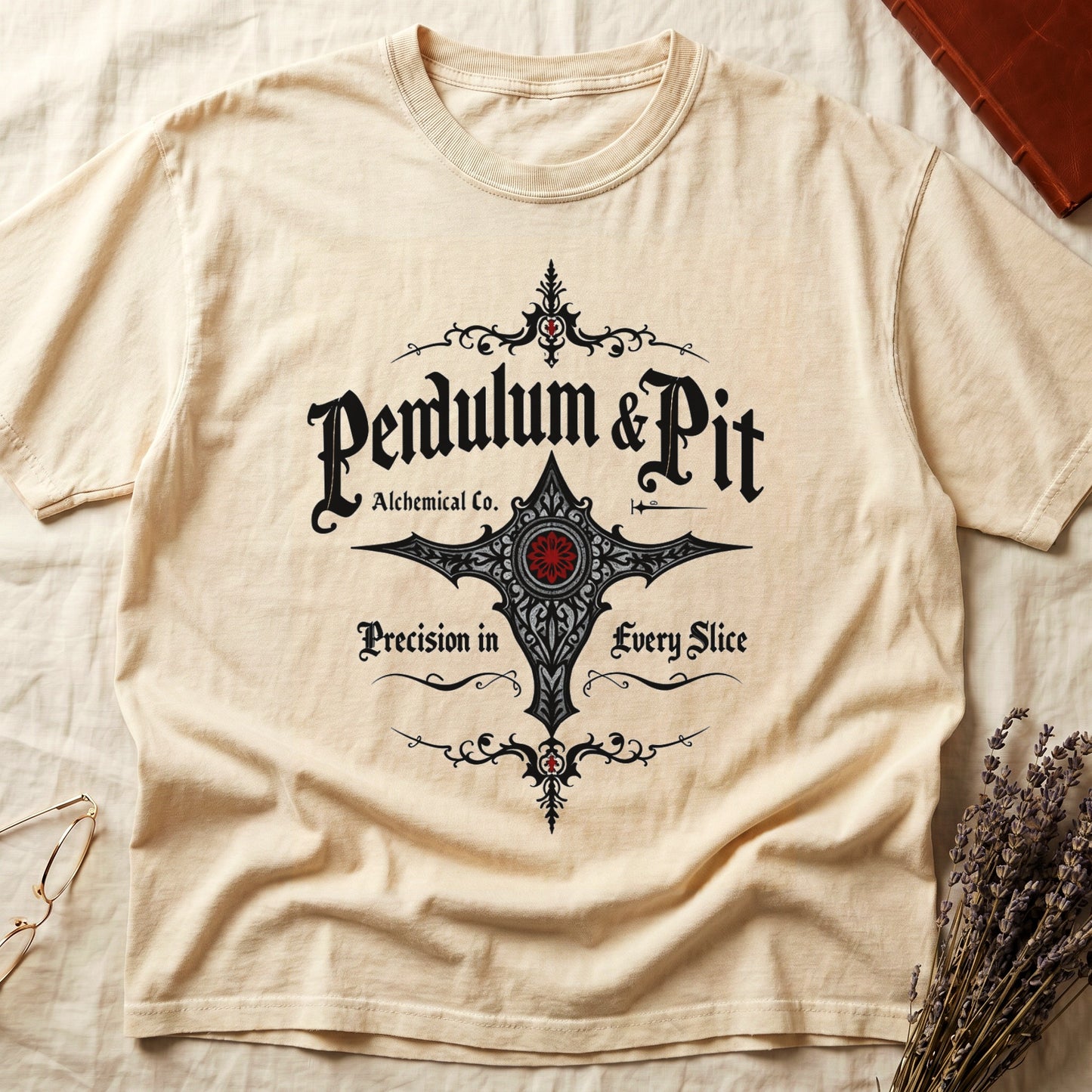 Ivory tee with white talismanic cross, "Pendulum & Pit Alchemical Co.," "Precision in Every Slice" banner ribbons.