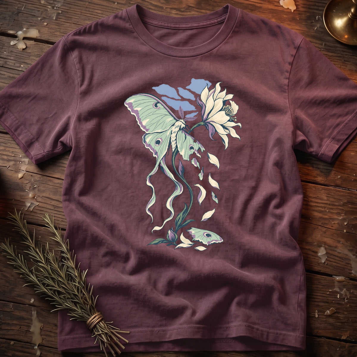 T-shirt with a moth and flower graphic, featuring flowing lines and soft colors.
