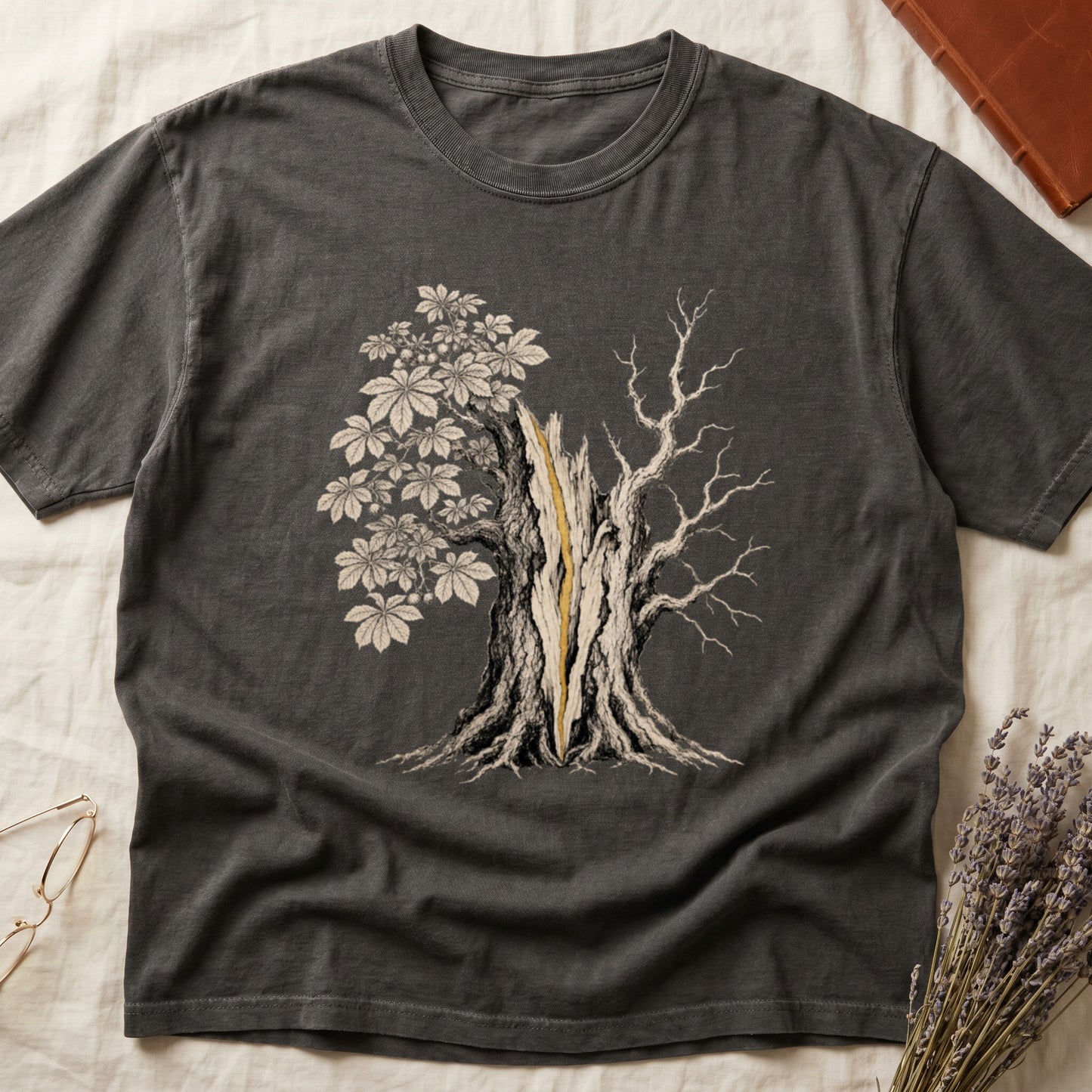 Charcoal t-shirt with a split tree graphic, one side leafy, the other bare.