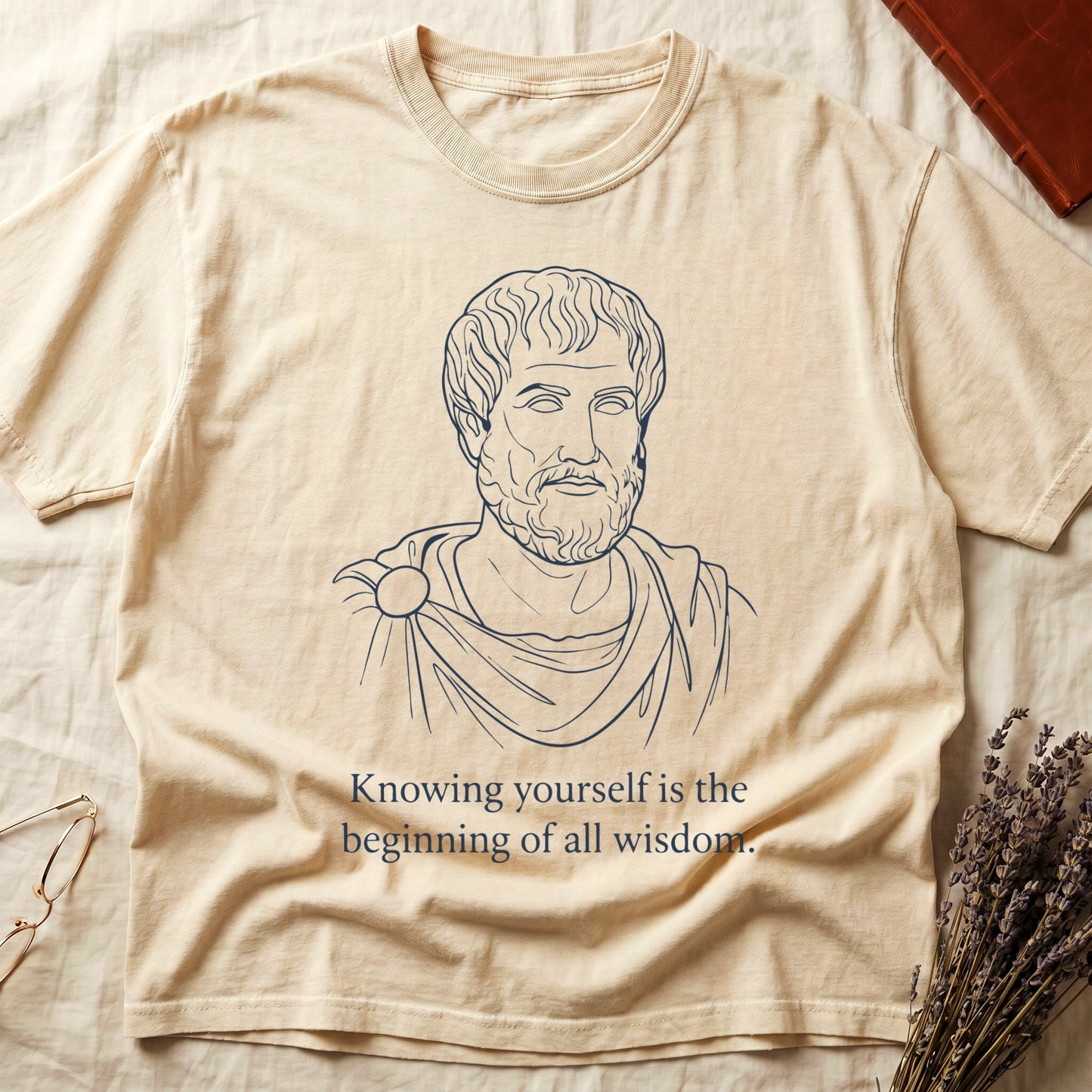 Ivory tee with classical philosopher bust in cream linework, "Knowing yourself is the beginning of all wisdom" below.