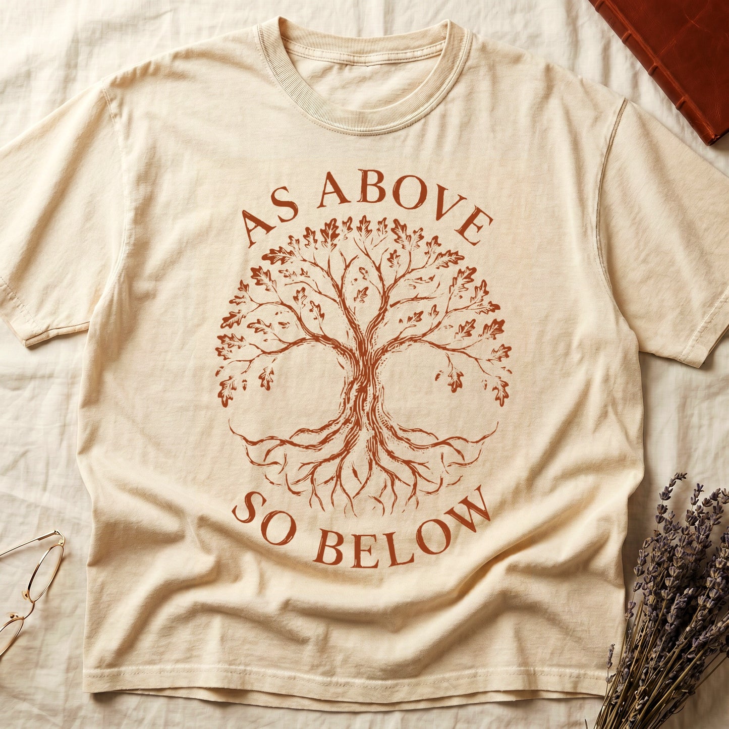 Ivory tee with Tree of Life in cream linework, mirrored canopy and roots, "AS ABOVE" and "SO BELOW" in serif arcs.