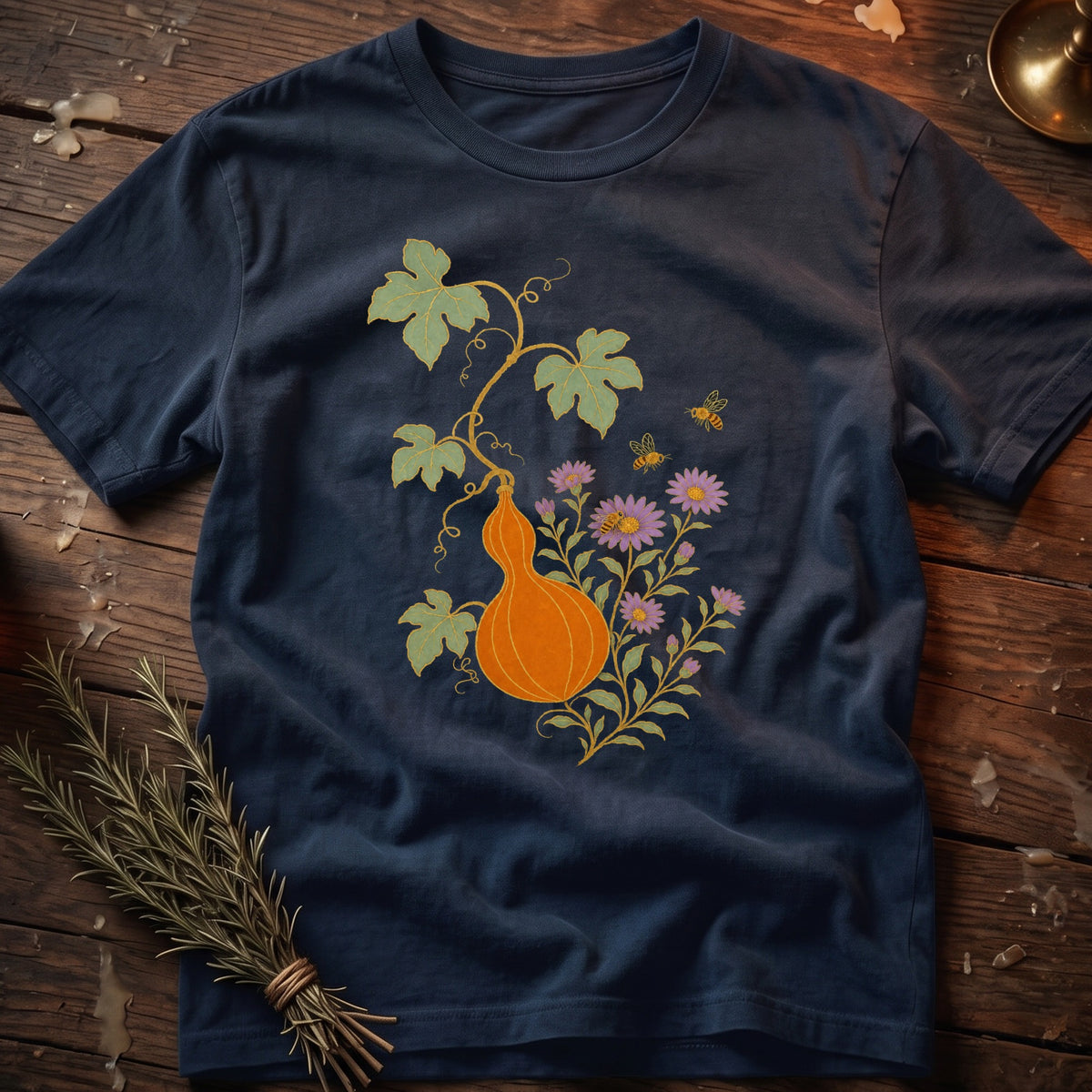 Navy t-shirt with orange gourd, purple flowers, and bees illustration.