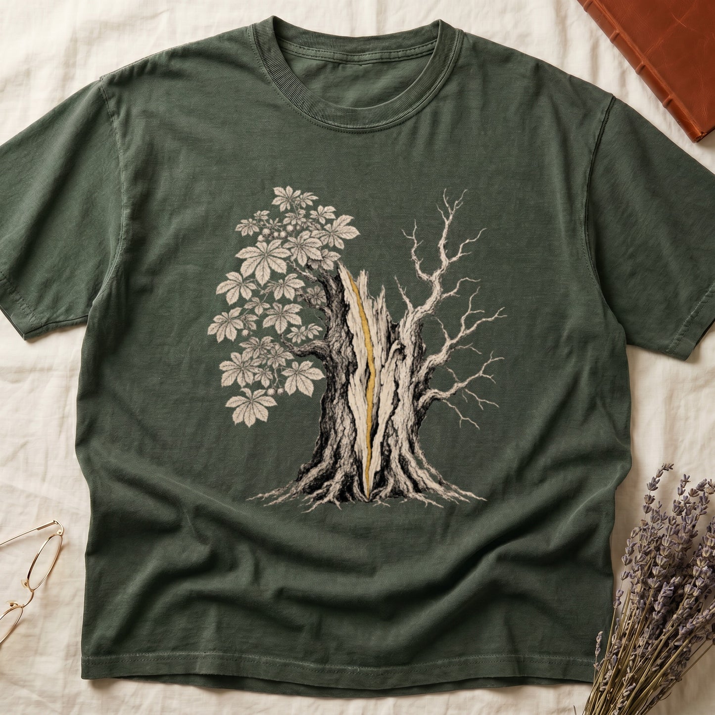 Green t-shirt with a split tree graphic, featuring a split trunk and contrasting leaf and branch sides.