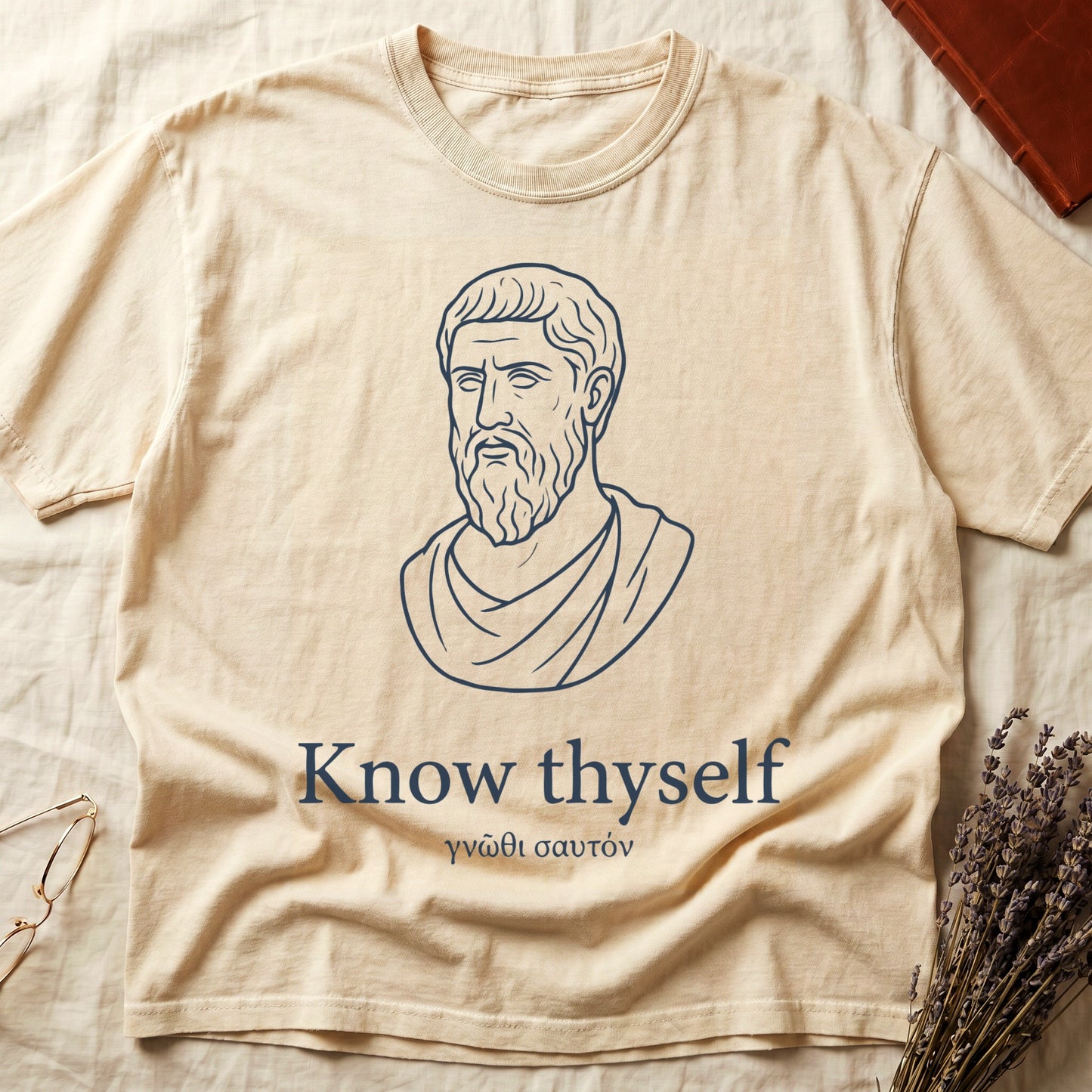 Ivory tee with classical Greek philosopher bust in white linework, "Know thyself" in cream serif below.