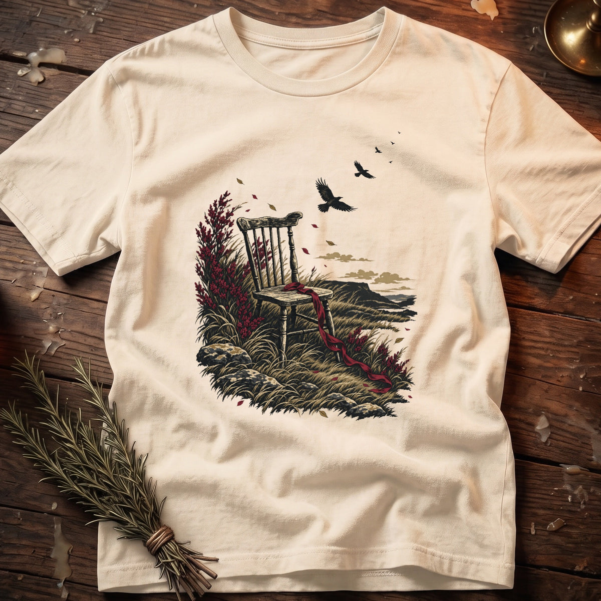Cream t-shirt with a dark illustration of an empty wooden chair with a red ribbon.