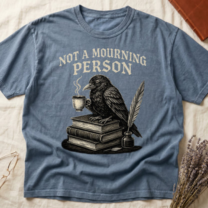 Espresso tee with raven holding coffee on stack of books, quill in inkwell, "NOT A MOURNING PERSON" distressed serif top.