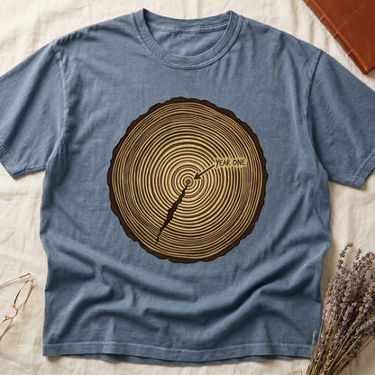 Blue Jean tee with cross-section of tree rings in warm brown, arrow pointing to center labeled "YEAR ONE" in serif type.