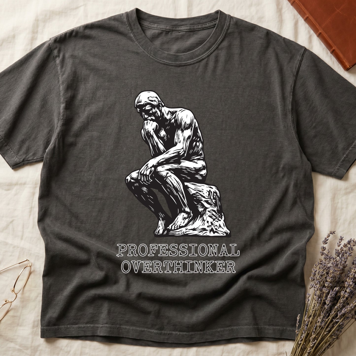 Pepper tee with monochrome rendering of Rodin's Thinker, "PROFESSIONAL OVERTHINKER" in serif capitals below.