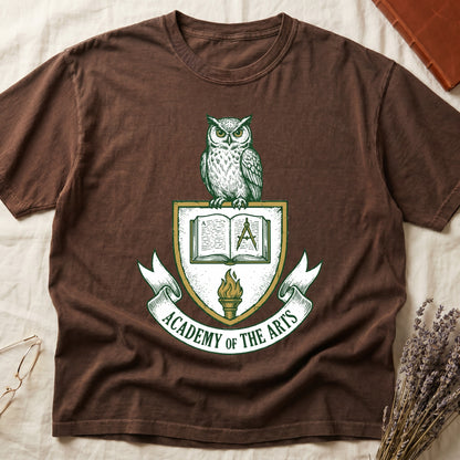 Espresso tee with heraldic shield crest, owl perched on top, open book and dividers center, "ACADEMY OF THE ARTS" on a banner.