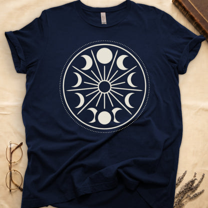 Navy tee with cream lunar orrery wheel, dotted ring, radial sunburst, moon phases around perimeter, central star.