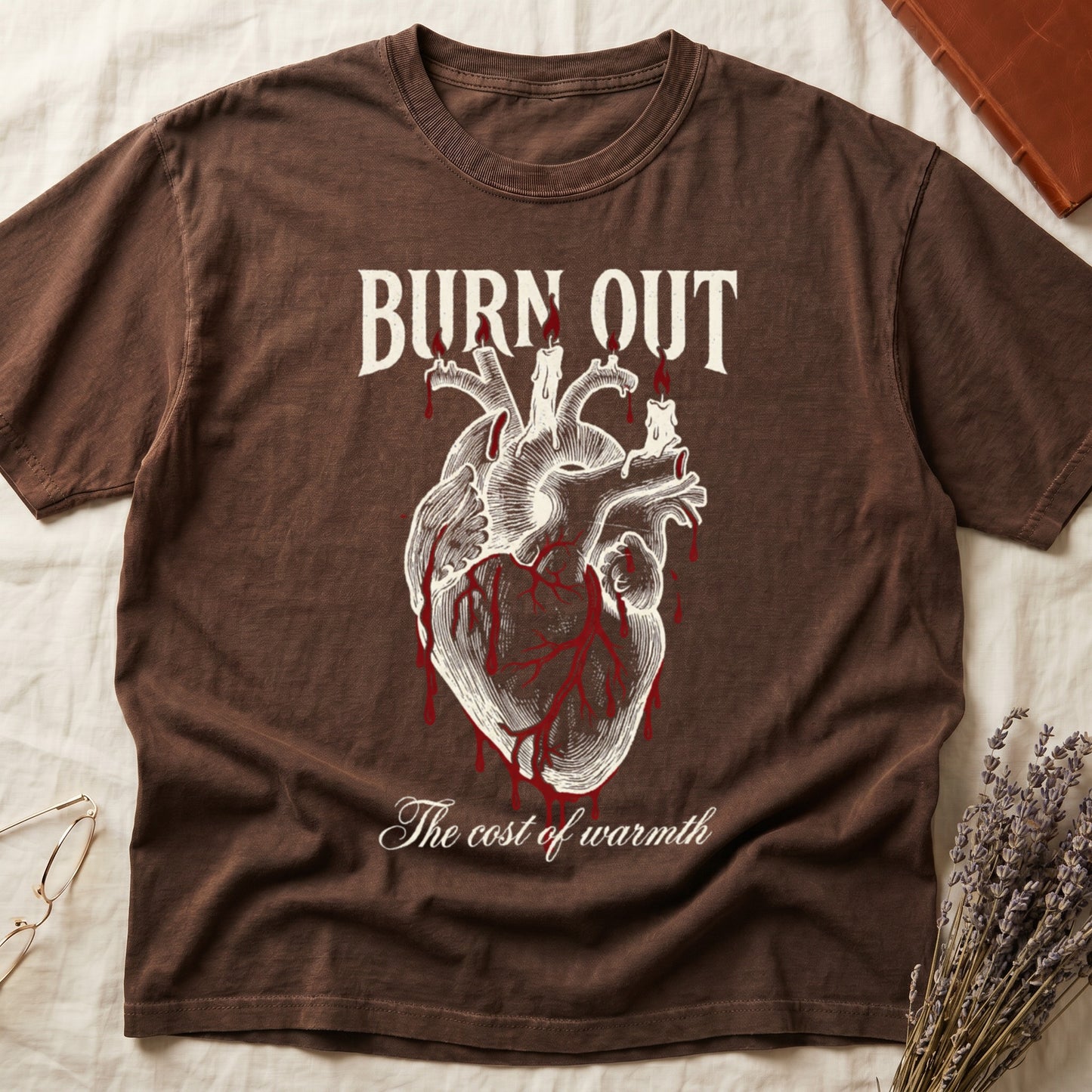 Espresso tee with anatomical heart and melted candles dripping red wax, "BURN OUT" top, "The cost of warmth" cursive below.