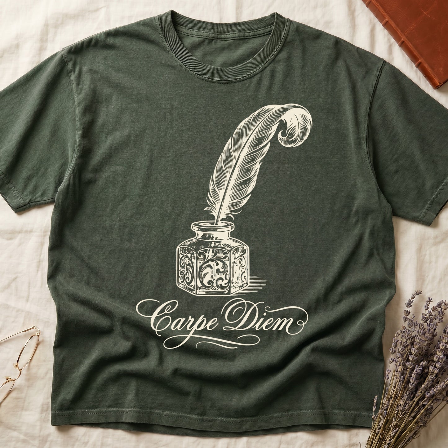 Green tee with ornate antique inkwell and quill pen in sepia linework, "Carpe Diem" in flowing cursive below.