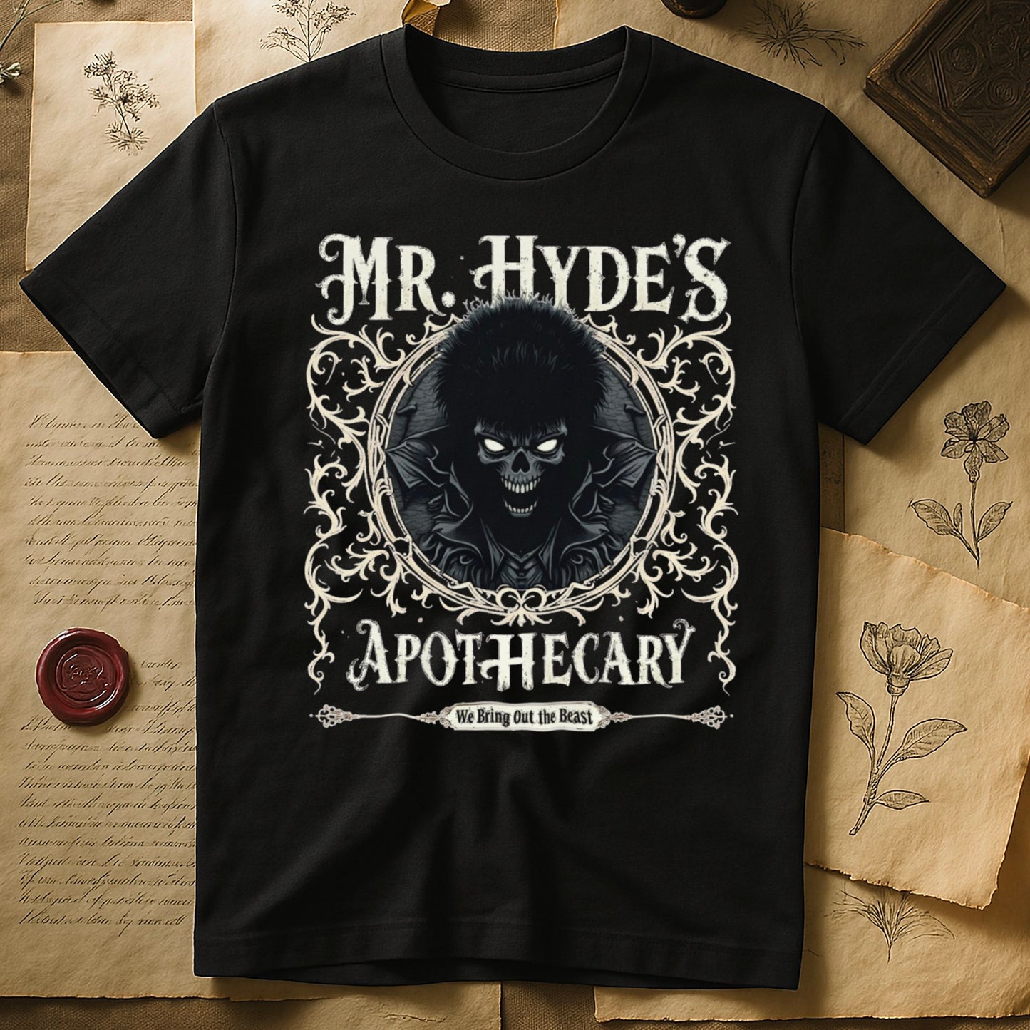 Black tee with ornate filigree frame, wild-haired skull figure, "MR. HYDE'S APOTECARY," "We Bring Out the Beast" below.