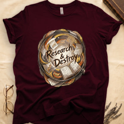 Maroon tee with globe of papers, open books, charts in colored ink, "Research & Destroy" in cursive at center.