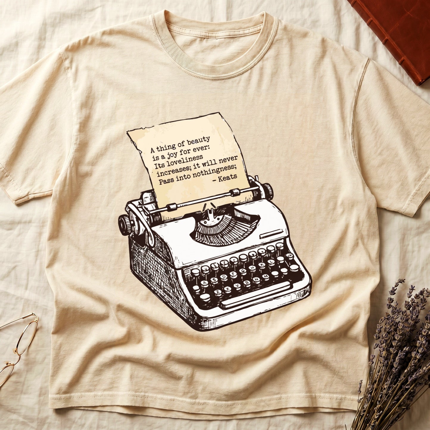 Ivory tee with vintage typewriter in cream linework, paper showing "A thing of beauty is a joy for ever" by Keats.