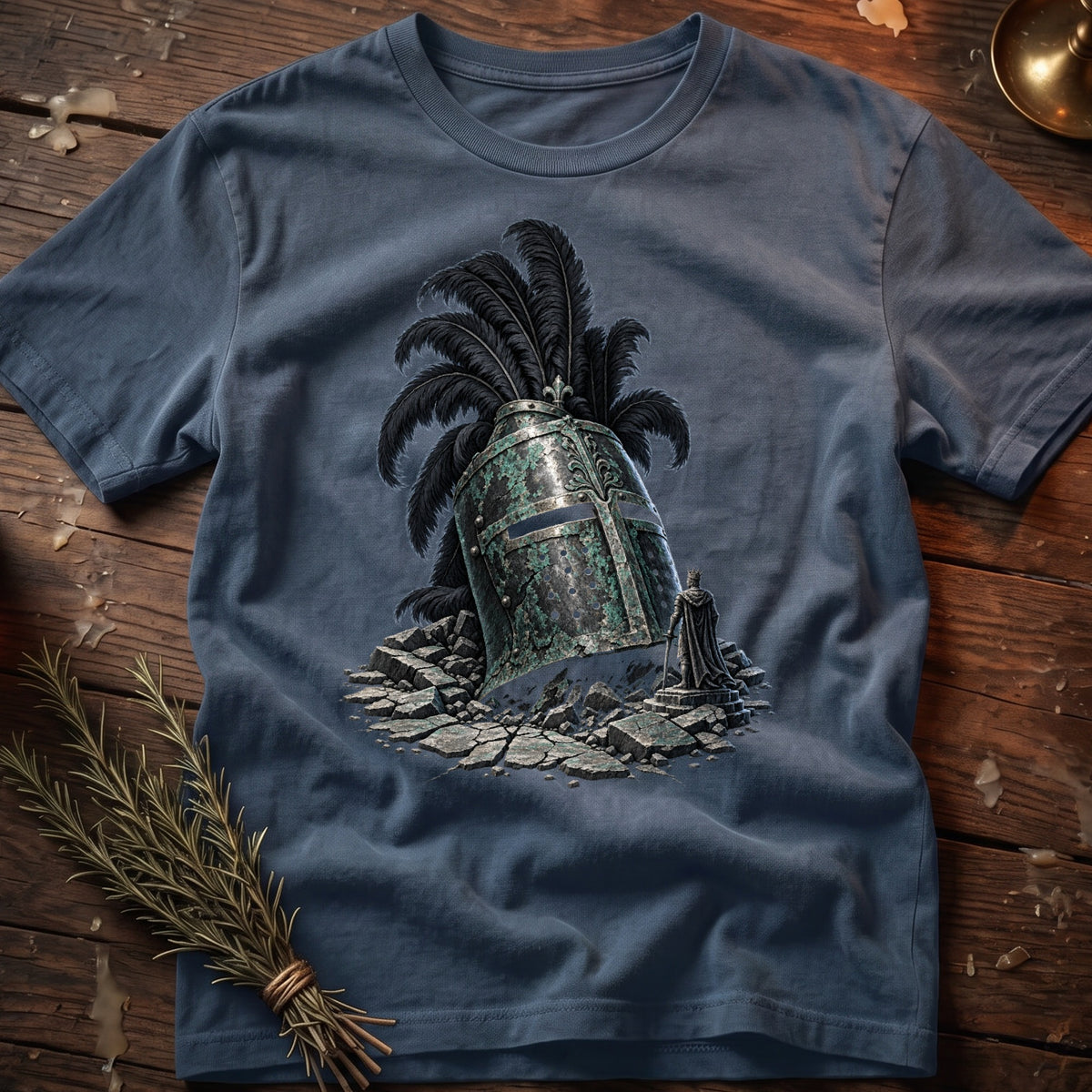Blue t-shirt with a graphic of a medieval helmet, feathers, and a king figure.