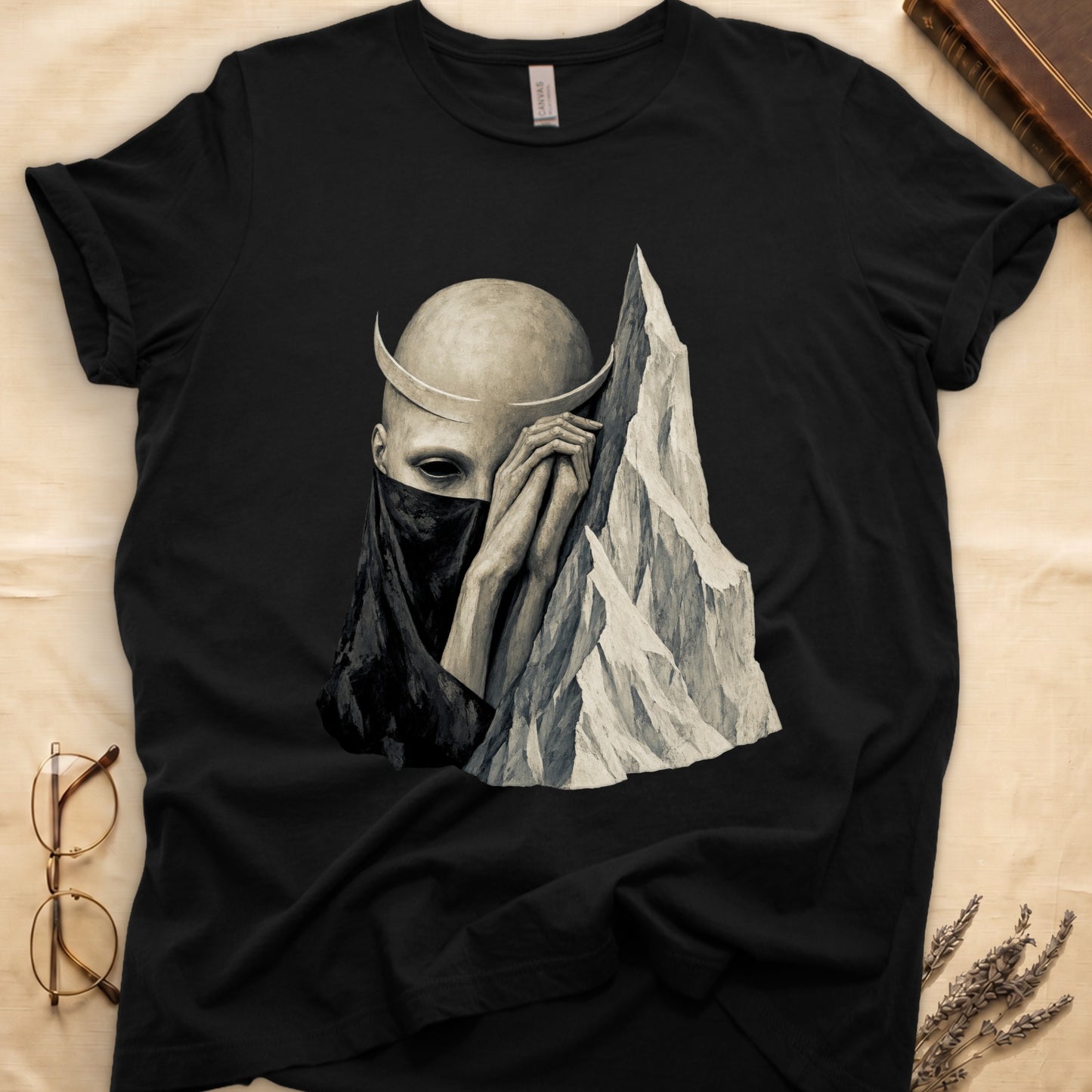 Black t-shirt with abstract artwork of a veiled head and mountain peak.