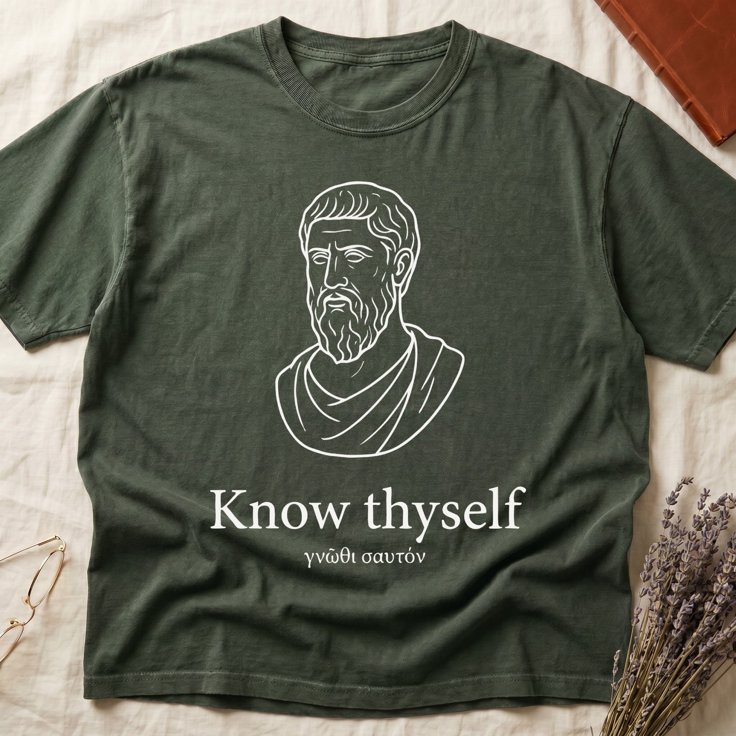 Green tee with classical Greek philosopher bust in white linework, "Know thyself" in cream serif below.