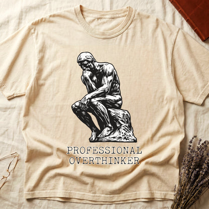 Ivory tee with monochrome rendering of Rodin's Thinker, "PROFESSIONAL OVERTHINKER" in serif capitals below.