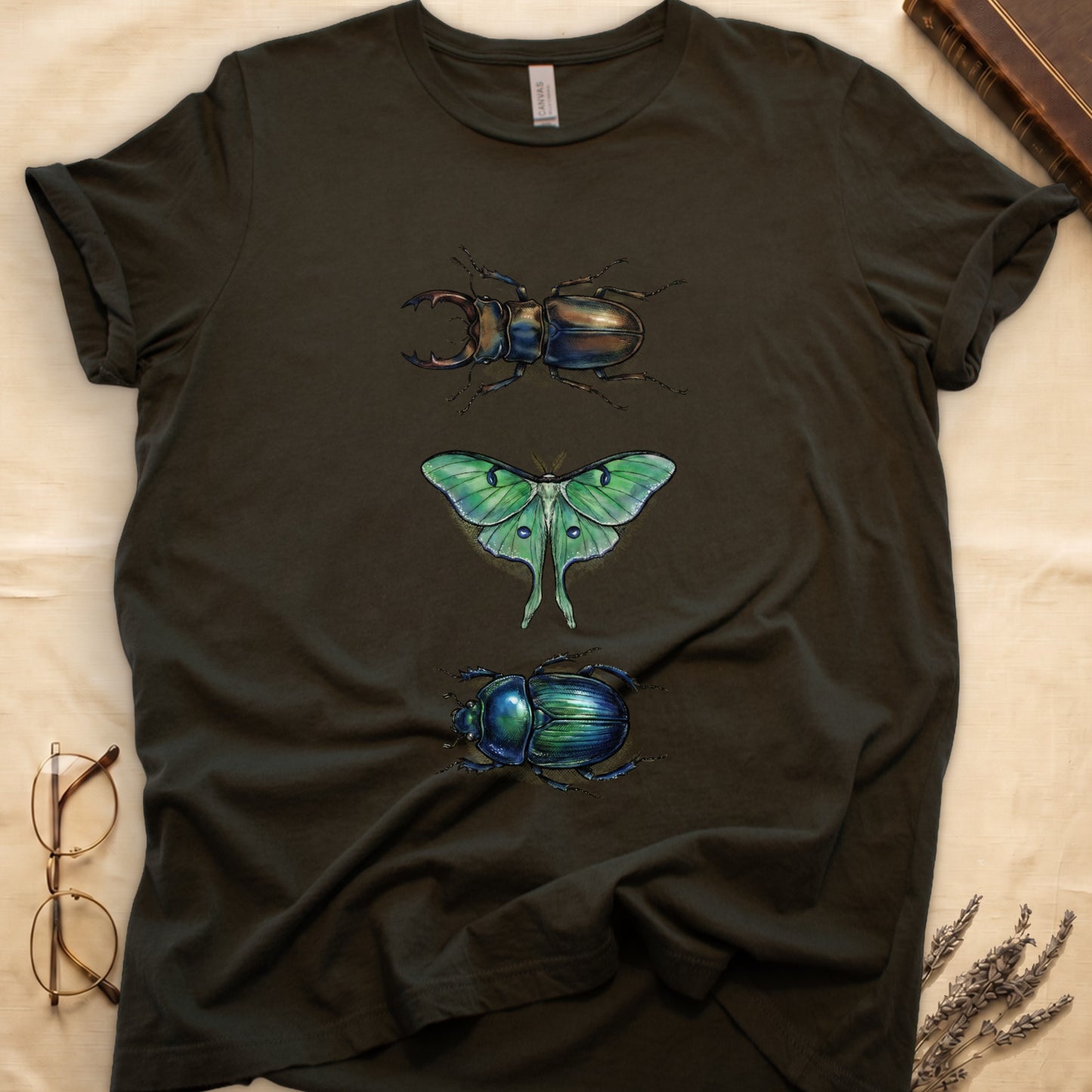 Black tee with three-panel Military Green-history plate: stag beetle, luna moth, scarab beetle in ink on yellow ground.