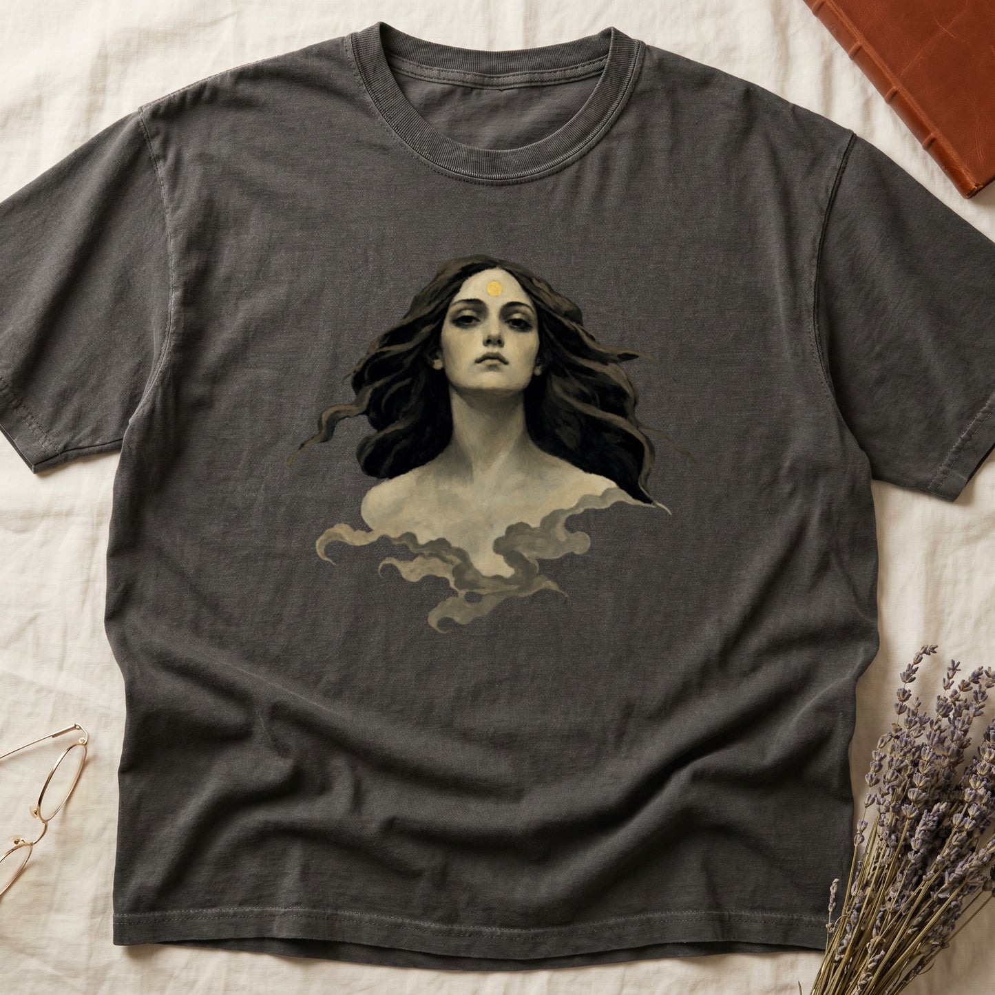 Dark grey t-shirt with a painting of a woman with flowing hair and a sun on her forehead.