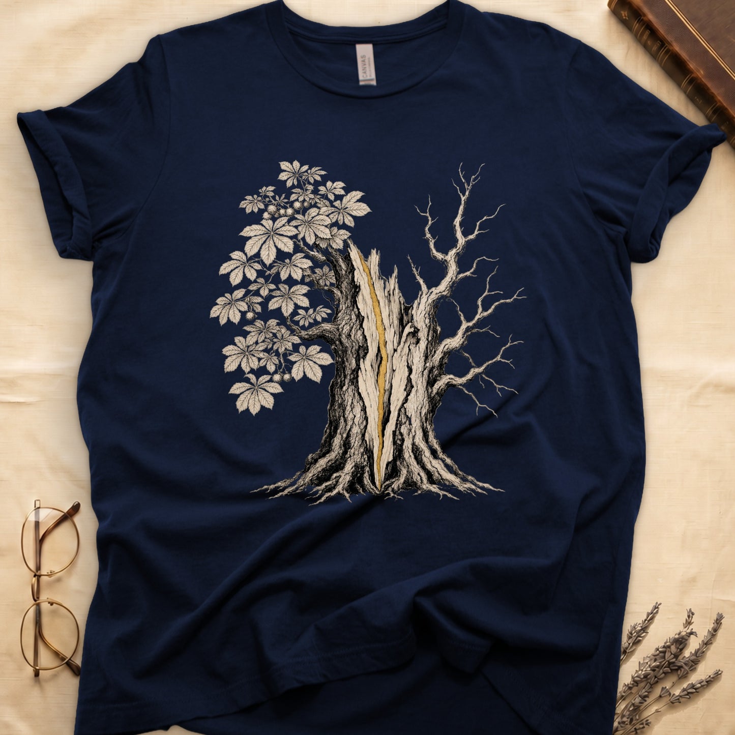Navy t-shirt with a detailed illustration of a split tree with one side leafed and the other bare.