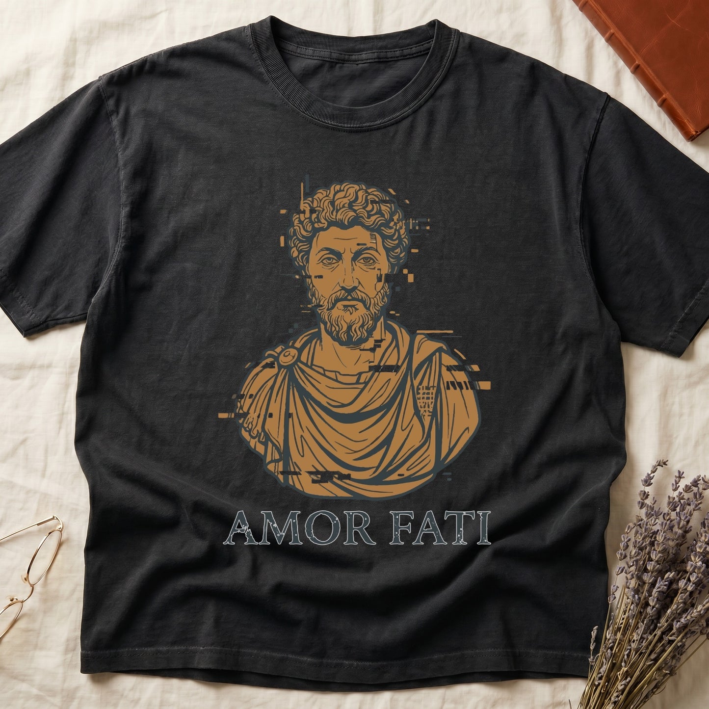 Black tee with bearded Stoic bust portrait in copper and slate, "AMOR FATI" in distressed serif capitals below.