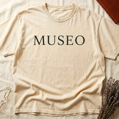 Ivory tee with "MUSEO" in oversized cream serif capitals, minimalist typographic design.