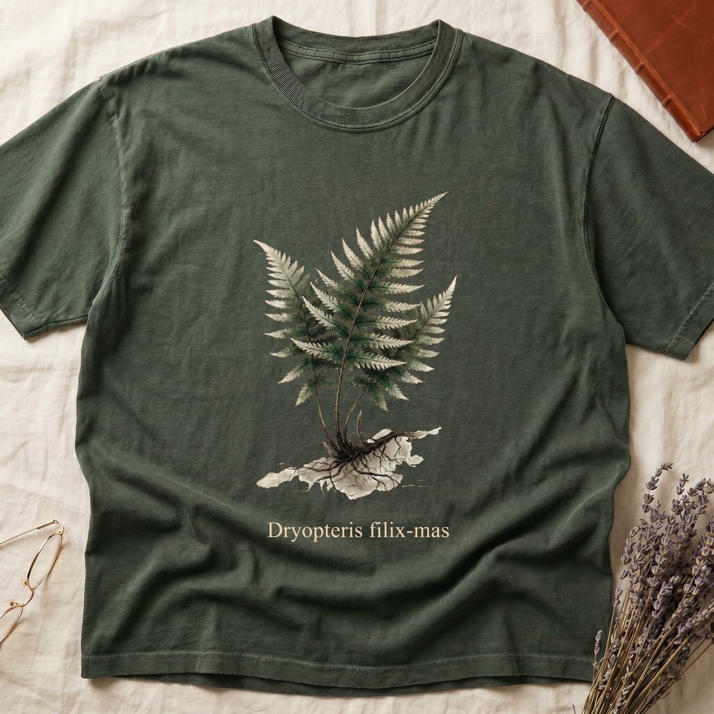 Green tee with Victorian fern illustration of Dryopteris filix-mas in greens with exposed root, italic Latin binomial below.