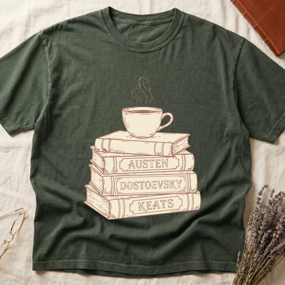 Green tee with stack of vintage books labeled "AUSTEN," "DOSTOEVSKY," "KEATS" topped with a steaming coffee cup.