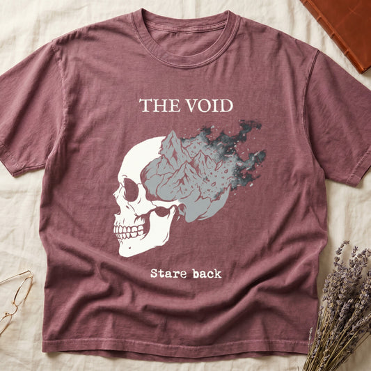 Dark Rose tee with skull eroding into mountain landscape and stardust, "THE VOID" top, "Stare back" typewriter below.