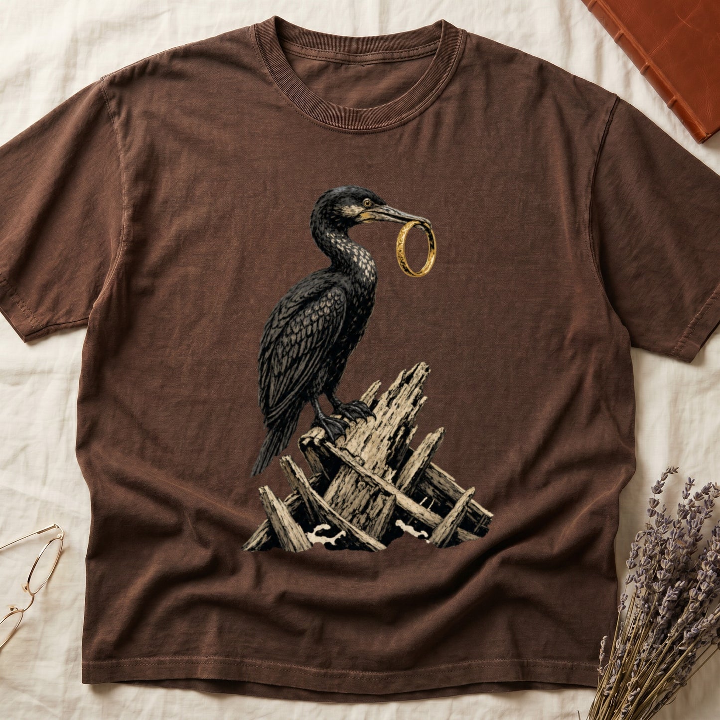 Brown t-shirt with a graphic of a cormorant holding a gold ring.