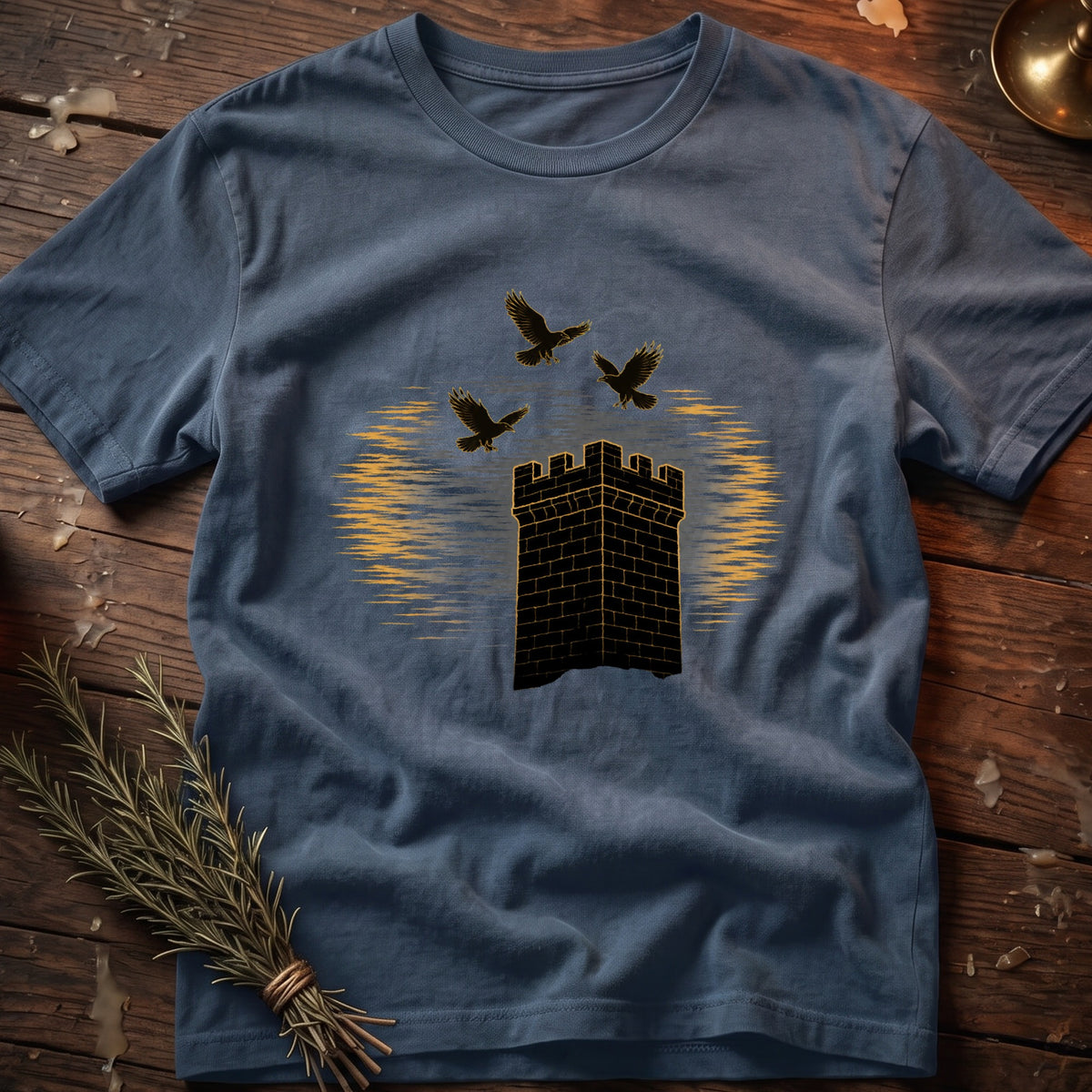 Slate blue t-shirt with a black brick tower and three black birds in flight.