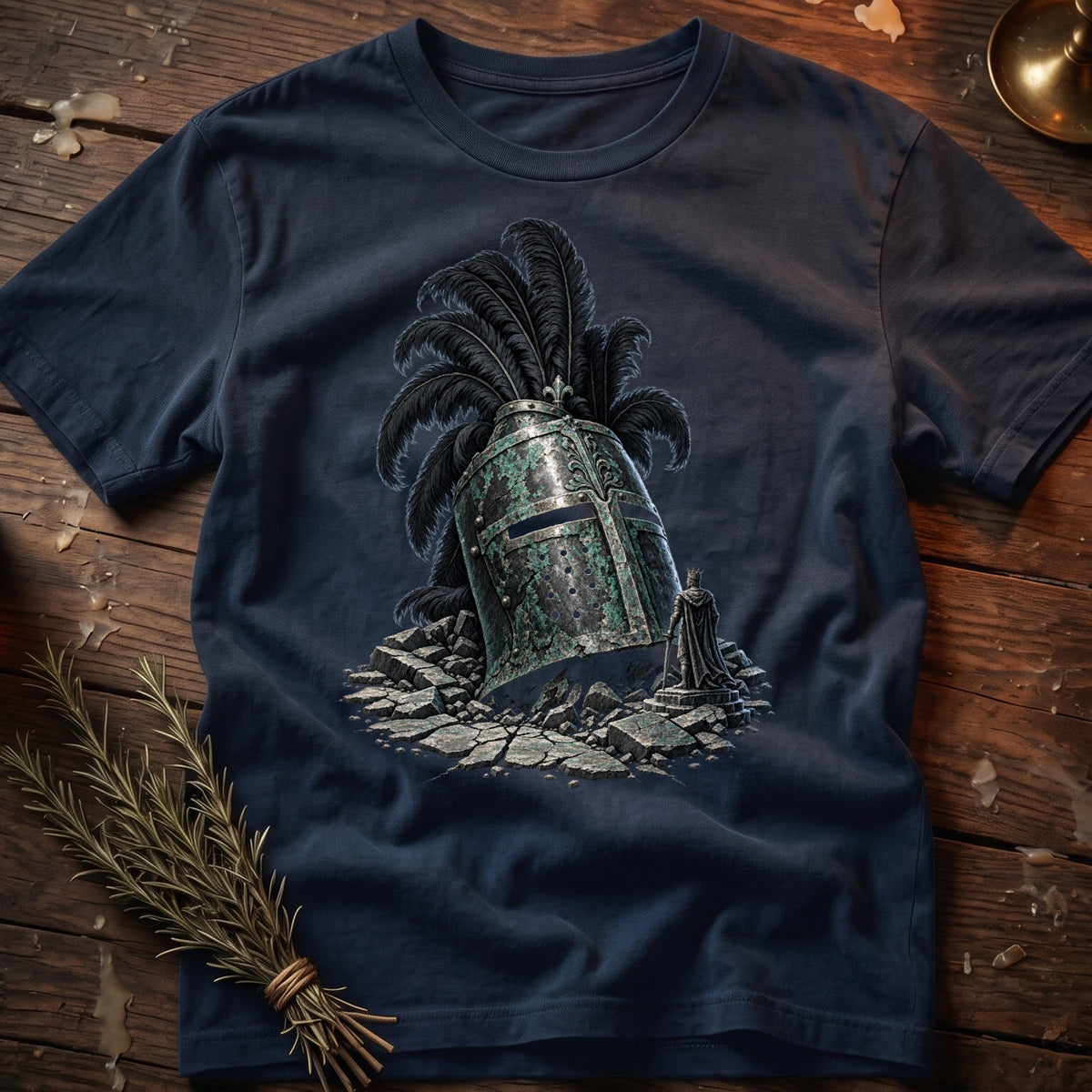 T-shirt with a graphic of a fallen knight's helmet and a small king figure.