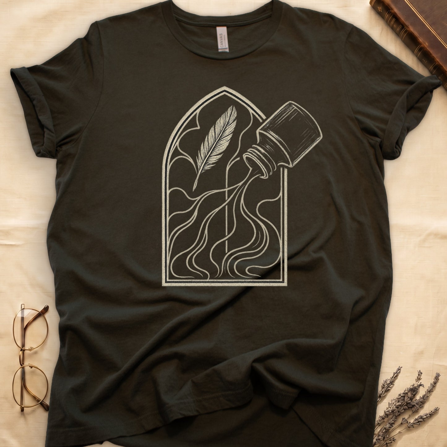 Military Green tee with sepia gothic arch, feather quill on left and tipped ink bottle on right spilling ink in curling tendrils.