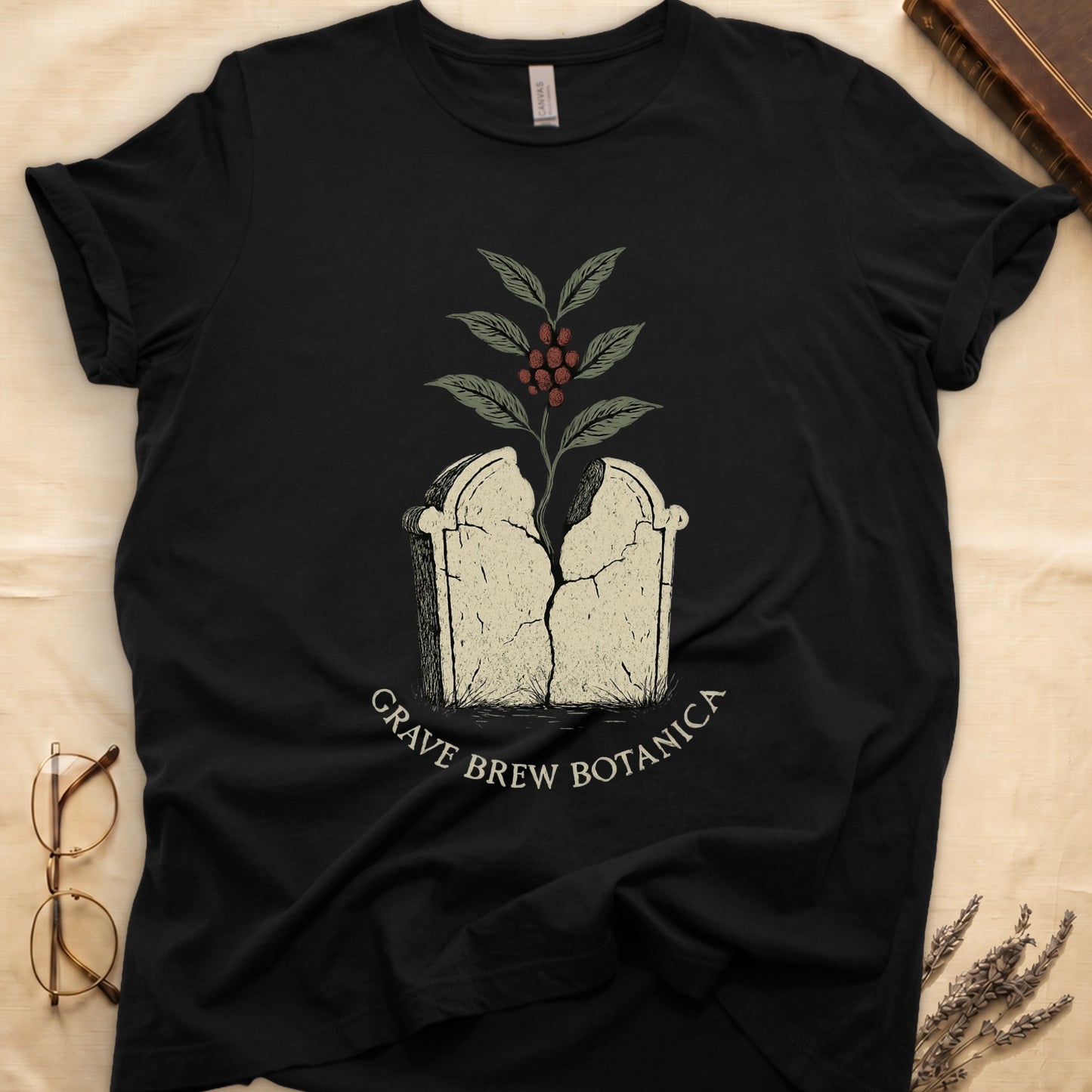 Black t-shirt with a cracked tombstone and coffee plant graphic. "Grave Brew Botanica" text.