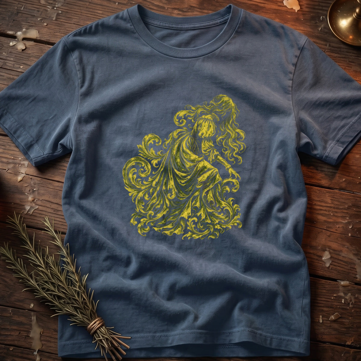 Blue t-shirt with a yellow ornate filigree design of a woman.