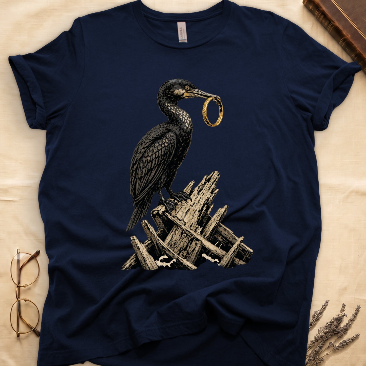 Dark t-shirt with a black bird holding a gold ring in its beak, perched on wood.