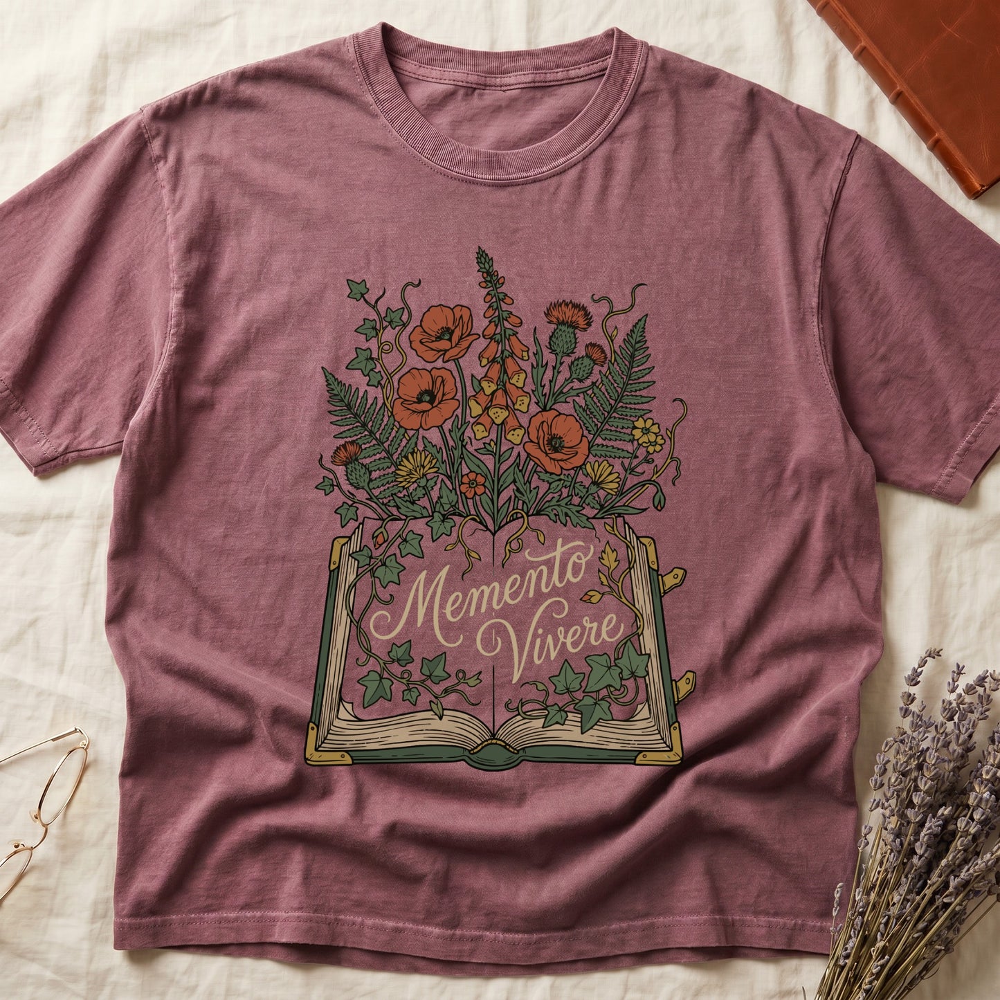 Dark Rose tee with open book and botanical illustration, red poppies, golden foxglove, ferns and ivy spilling from the pages.