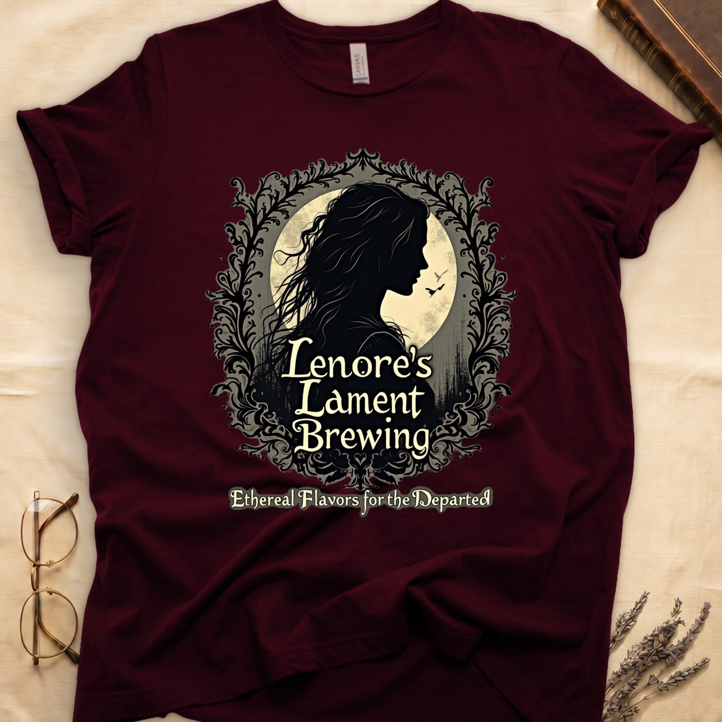 Maroon tee with sage label, Lenore silhouette and moon, "Lenore's Lament Brewing," "Ethereal Flavors for the Departed."