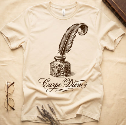Natural tee with ornate antique inkwell and quill pen in sepia linework, "Carpe Diem" in flowing cursive below.