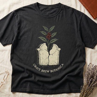 Dark t-shirt with cracked tombstone design and coffee plant, text reads Grave Brew Botanica.