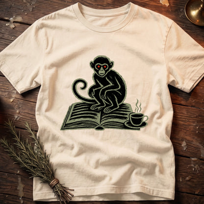 Monkey with red eyes sitting on an open book next to a steaming coffee cup.