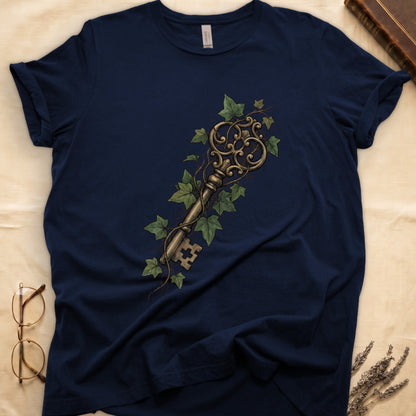 Navy tee with ornate antique skeleton key in bronze, climbing English ivy in green on terracotta ground.